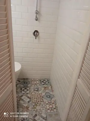a bathroom with a shower with a tiled floor at Maqueda Suite Palermo at Cathedral in Palermo