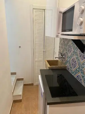a kitchen with a sink and a microwave at Maqueda Suite Palermo at Cathedral in Palermo