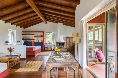 a living room with a table and a couch at Tenuta dei Principi di Spadafora in Bosco Fraccia