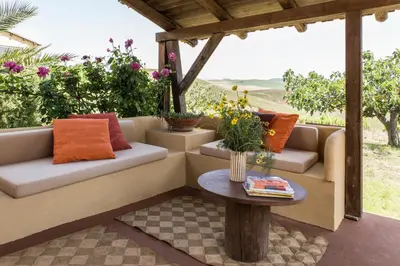 a patio with two couches and a table at Tenuta dei Principi di Spadafora in Bosco Fraccia