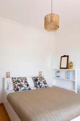 a bed in a bedroom with a chandelier at Tenuta dei Principi di Spadafora in Bosco Fraccia