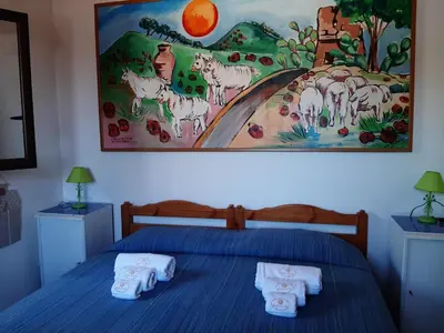 a bedroom with a bed with towels on it at Villetta Edera all'Usciere in San Vito lo Capo