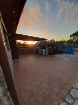 a view of a patio with the sun setting at Villetta Edera all'Usciere in San Vito lo Capo
