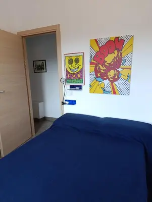 a bedroom with a bed and posters on the wall at Villa Casa di Franca - 700 meters from the sea Scopello in Castellammare del Golfo