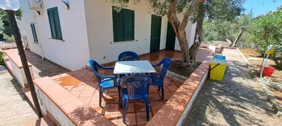 a table and chairs sitting on a patio at Villa Casa di Franca - 700 meters from the sea Scopello in Castellammare del Golfo