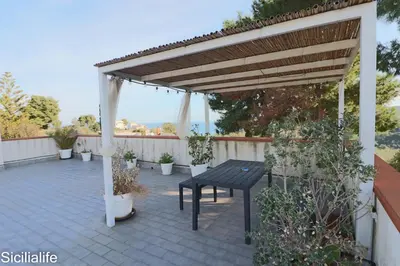 a wooden pergola with a picnic table on a patio at Villa Casa di Franca - 700 meters from the sea Scopello in Castellammare del Golfo