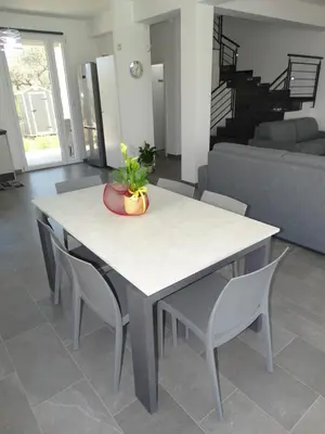 a white table and chairs in a living room at Villa Milicia - New Private Villa near Palermo and Cefalù with Pool, Sea View Terrace, Playground and Large Parking in Altavilla Milicia