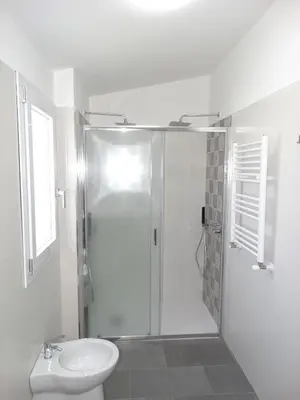 a bathroom with a shower and a toilet and a sink at Villa Milicia - New Private Villa near Palermo and Cefalù with Pool, Sea View Terrace, Playground and Large Parking in Altavilla Milicia