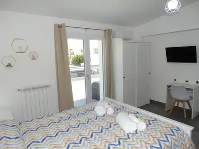 a bedroom with a bed and a sliding glass door at Villa Milicia - New Private Villa near Palermo and Cefalù with Pool, Sea View Terrace, Playground and Large Parking in Altavilla Milicia
