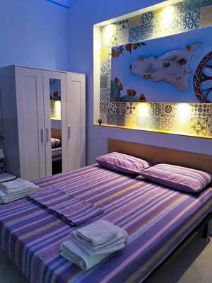 a bedroom with a bed with towels on it at La Loggia 34 in Palermo