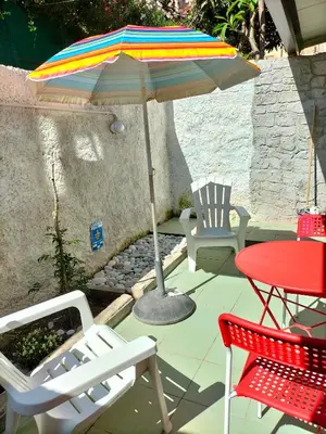 a patio with a table and an umbrella and chairs at La Loggia 34 in Palermo