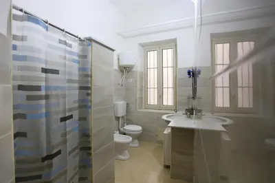 a bathroom with a sink and a toilet and a shower at ZU' NICOLA in Palermo