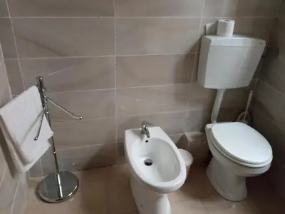 a bathroom with a toilet and a sink in it at ZU' NICOLA in Palermo