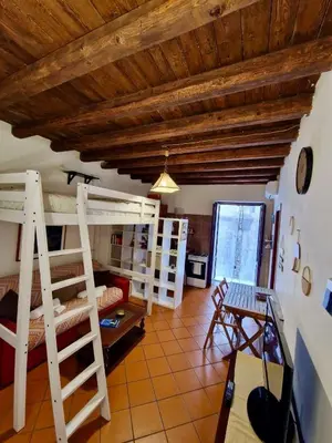 a living room with bunk beds and a room with a table at Old Town Loft - Palermo in Palermo