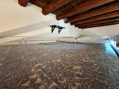 a bedroom with a large bed with a brown bedspread at Old Town Loft - Palermo in Palermo