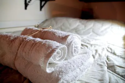 a white bed with a towel on it at Old Town Loft - Palermo in Palermo