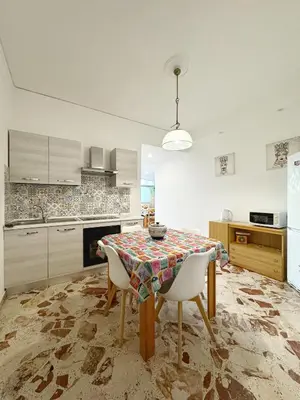 a kitchen with a table and chairs in a room at Casa Indipendenza - Cattedrale in Palermo