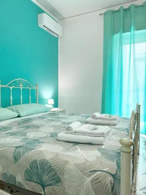a bedroom with a large bed with towels on it at Casa Indipendenza - Cattedrale in Palermo