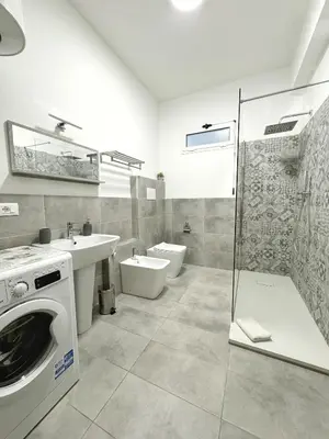 a bathroom with a sink and a washing machine at Casa Indipendenza - Cattedrale in Palermo