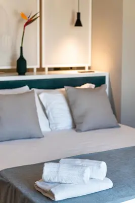 a bed with two towels sitting on top of it at Limen Wellness Hotel & Spa in Campofelice di Roccella