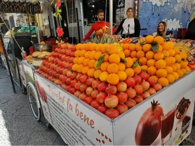 a fruit stand with oranges and other fruits on it at BALLARHOUSE in Palermo