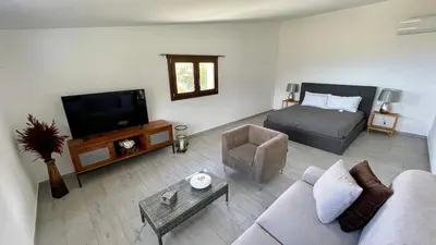 a living room with a couch and a bed at Villa Felice - SEAVIEWS & PRIVATE POOL in Scopello