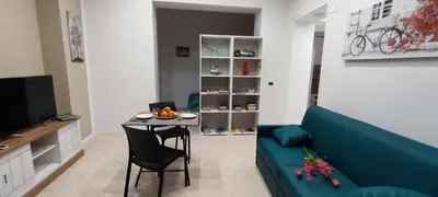 a living room with a blue couch and a table at Leam Apartment 5 in Palermo
