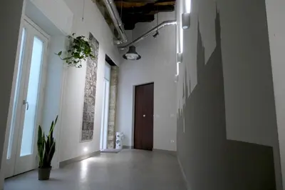 an empty hallway with white walls and a door at Opera Suites - Aida in Palermo
