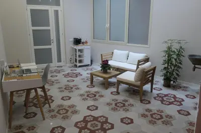 a living room with a couch and a chair and a table at Opera Suites - Aida in Palermo