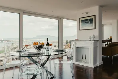 a dining room with a glass table and a fireplace at TOP OF THE PORT in Palermo
