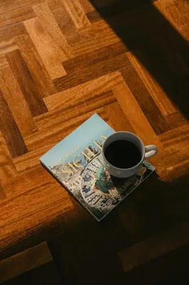 a cup of coffee sitting on top of a wooden floor at TOP OF THE PORT in Palermo