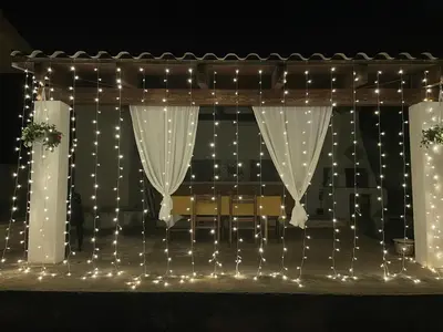 a stage with white curtains and lights at Villa Contrada Sauci in San Vito lo Capo