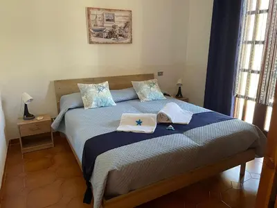 a bedroom with a bed with towels on it at Villa Contrada Sauci in San Vito lo Capo
