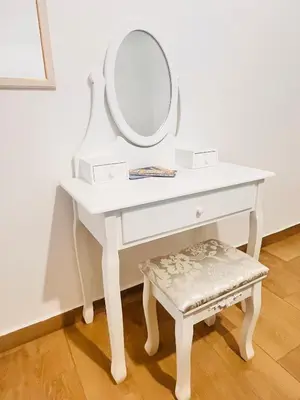 a white dressing table with a mirror and a stool at Casa vacanza CUTÓ in Bagheria