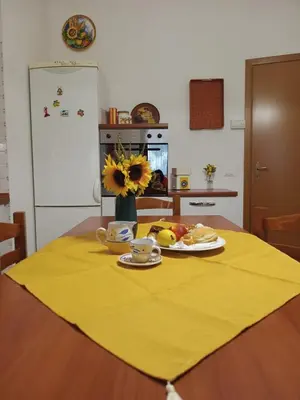 a table with a plate of food on a yellow table cloth at SanVitoTour- Appartamento Smeraldo in San Vito lo Capo