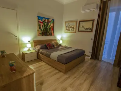 a bedroom with a bed and two lamps and a table at Quintino 57 Al Politeama - Tourist Lease in Palermo