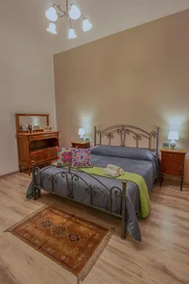a bedroom with a metal bed with pillows on it at Quintino 57 Al Politeama - Tourist Lease in Palermo