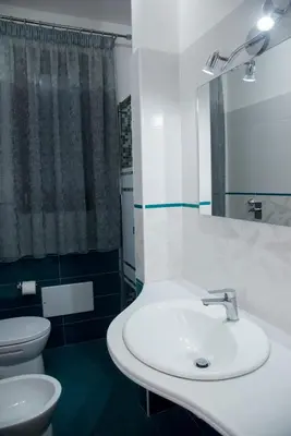 a bathroom with a sink and a toilet at Casa Diamante in San Vito lo Capo