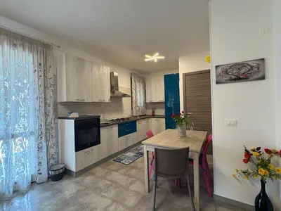 a kitchen with a table and a dining room at Casa Diamante in San Vito lo Capo