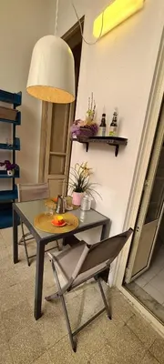 a table and a chair in a room at Appartamento centro in Palermo