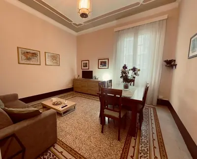 a living room with a couch and a table at Appartamento centro in Palermo