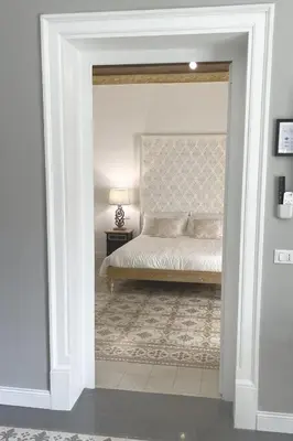 a bedroom with a bed in a white room at Dimora Borghese “Florio” in Palermo