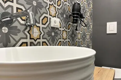 a white sink in a bathroom with a shower at Dimora Borghese “Florio” in Palermo