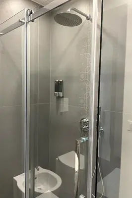 a bathroom with a glass shower with a toilet at Dimora Borghese “Florio” in Palermo