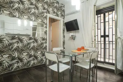 a dining room with a glass table and chairs at 4 Canti Central cozy apt in via Maqueda in Palermo