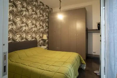 a bedroom with a yellow bed and a cabinet at 4 Canti Central cozy apt in via Maqueda in Palermo