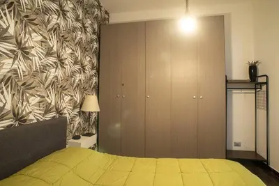 a bedroom with a yellow bed and a wall at 4 Canti Central cozy apt in via Maqueda in Palermo