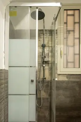 a shower with a glass door in a bathroom at 4 Canti Central cozy apt in via Maqueda in Palermo