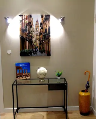 a table in a room with a picture on the wall at Massimo Luxury Rooms in Palermo