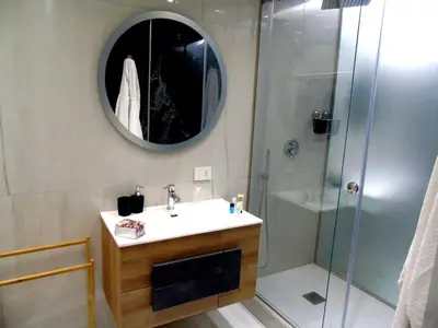 a bathroom with a sink and a shower with a mirror at Massimo Luxury Rooms in Palermo